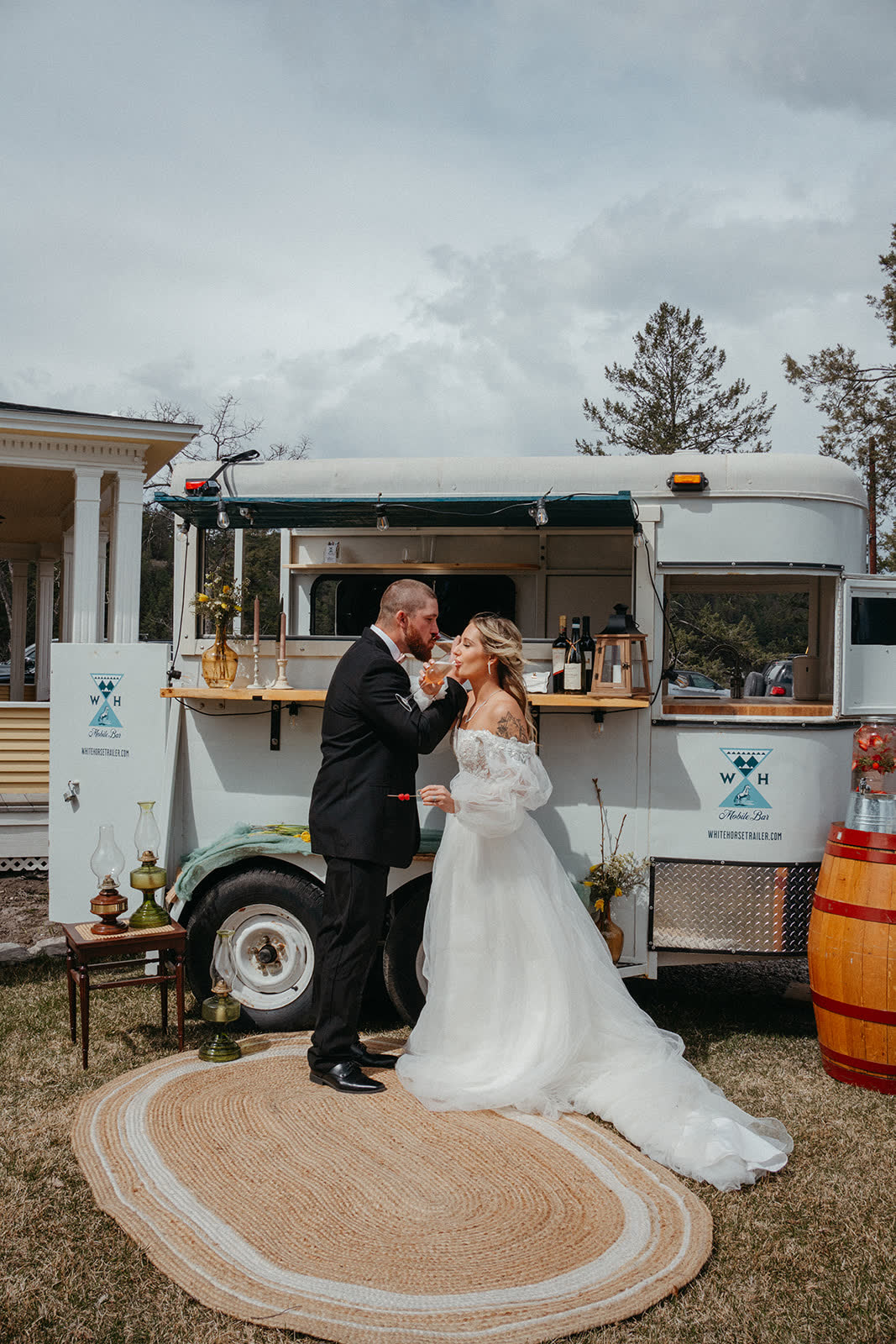 Couple sharing a first dance beside the mobile bar at their Montana wedding