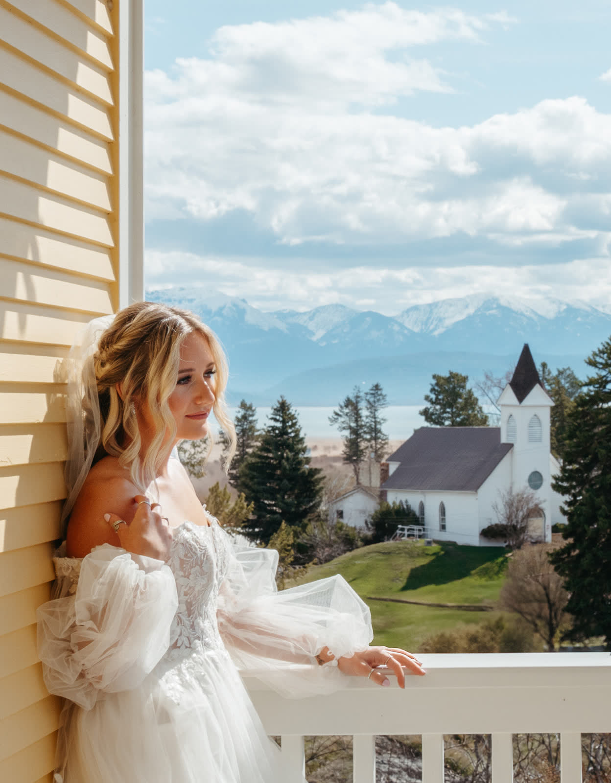 Bride on a veranda overlooking Flathead Lake and the mountains